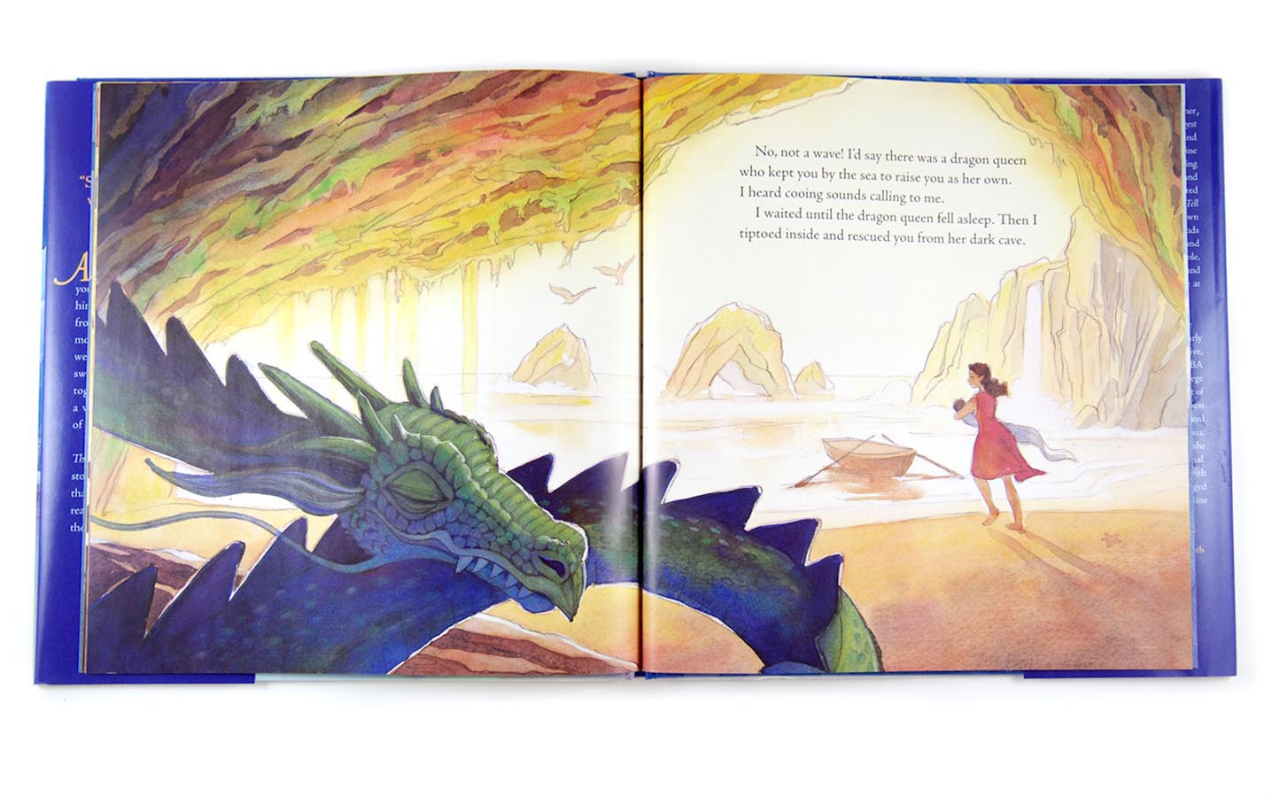 Photograph of The Story I'll Tell book, open to a page showing a large sleeping dragon. In the background, a mother runs with a baby in her arms toward a small rowboat.